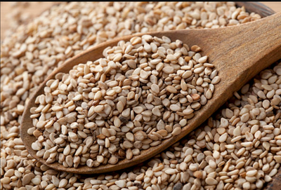 Wooden spoon of sesame seeds, an ingredient in Lebanese za'atar and several Jar Thuraya jams